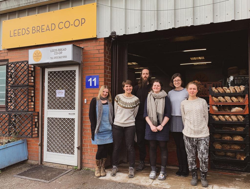 Members of the Leeds Bread Co-op standing outside the bakery premises