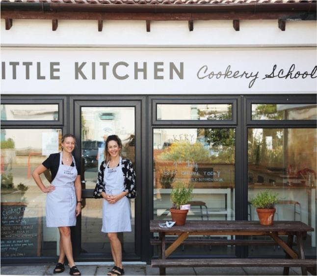 Little Kitchen's two co-owners, Madeleine and Claire, standing outside the front of the cookery school building