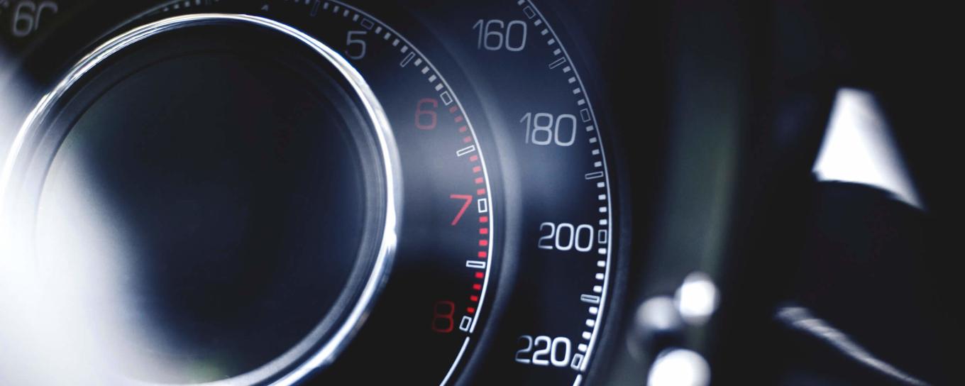 A close up of a speedometer in a car