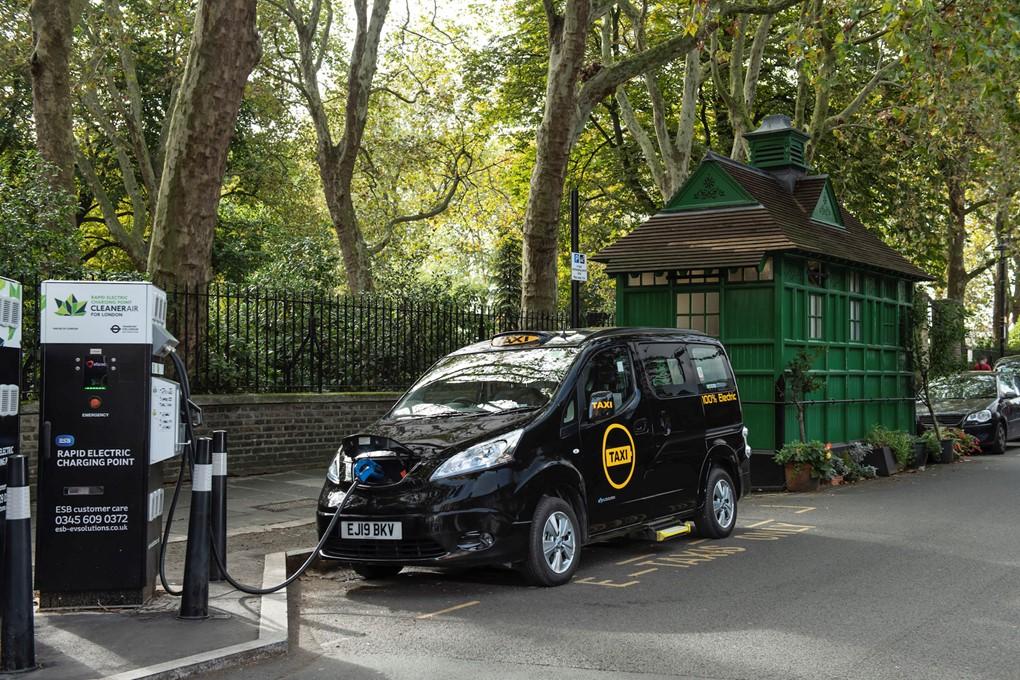 An electric London black cab charging its battery at a charging station