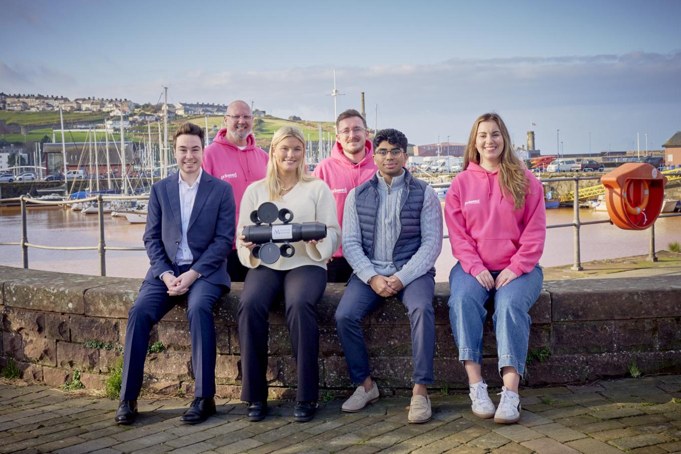 A group of people sitting from the Scrubmarine company